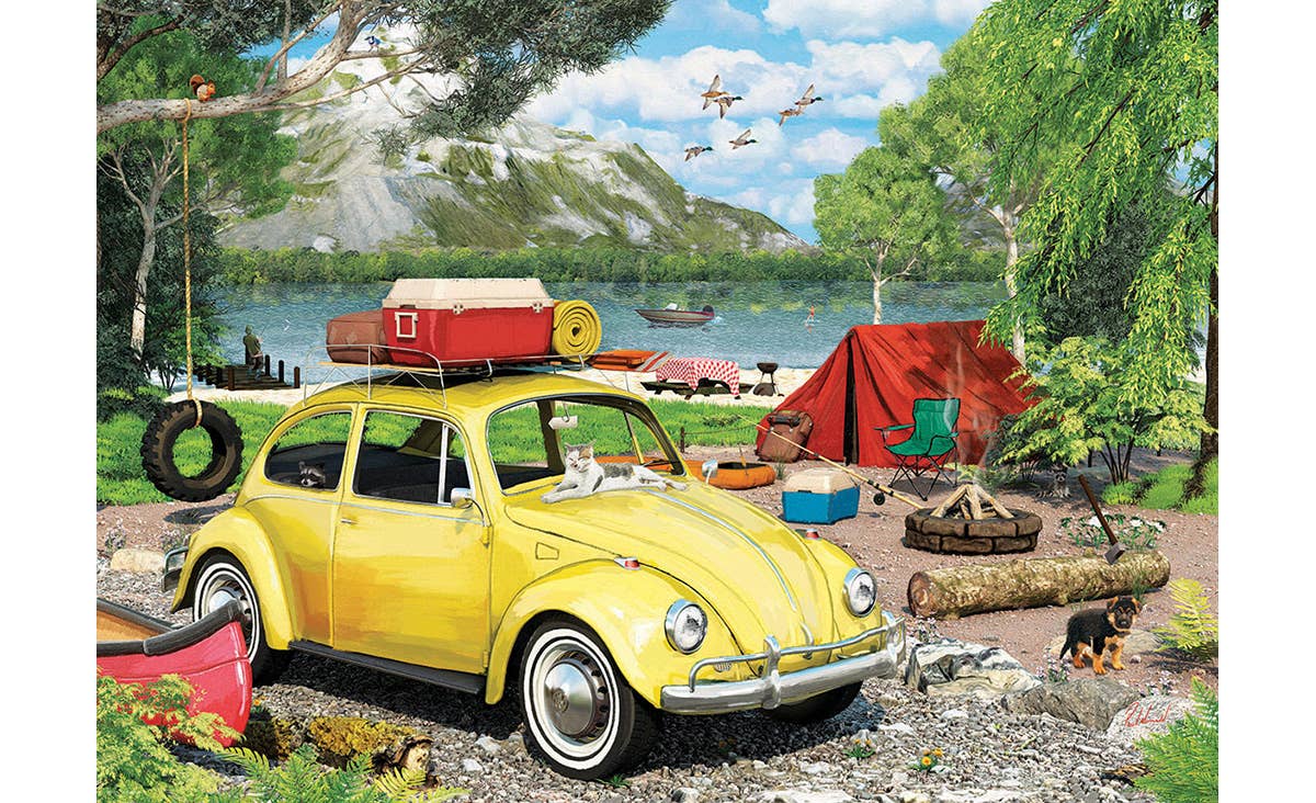 Yellow vintage car with luggage at a campsite by a lake
