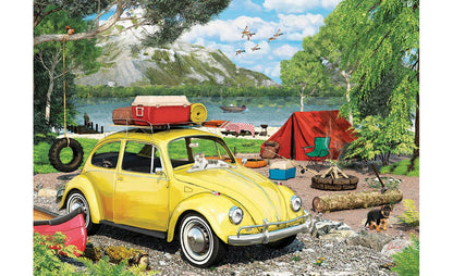 Yellow vintage car with luggage at a campsite by a lake