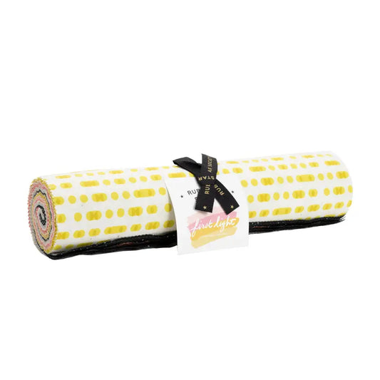 A roll of fabric with a yellow color and geometric dot pattern, likely a part of the 'First Light' layer cake by Ruby Star Society. Bundle of 42 10" squares. 100% Premium Cotton for quilting and crafting. 