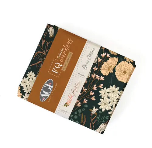A bundle of fat quarters featuring a floral pattern in various colors, with the brand name 'Wild Forgotten' and the designer's signature 'Bonnie Christine' from Art Gallery Fabrics. 100% premium  cotton for quilting and sewing. 